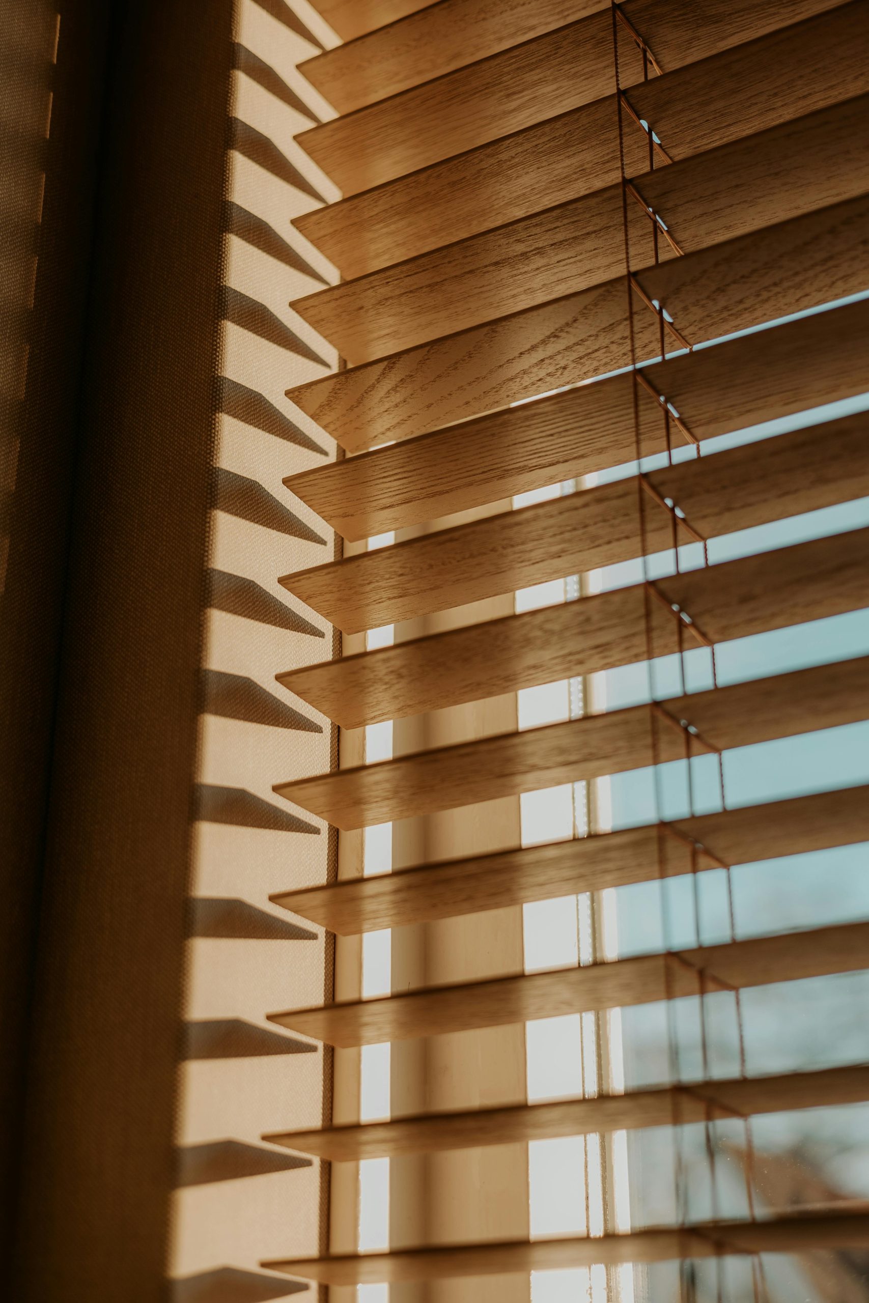 Sunlight filtering through wooden blinds creates a warm and calming atmosphere.